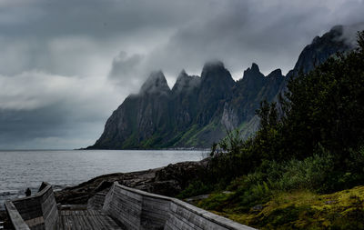 Panoramic view of sea and mountains against sky