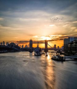 Scenic view of river against sky during sunset