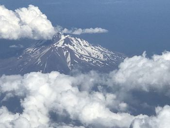 Aerial view of snowcapped mountain against sky