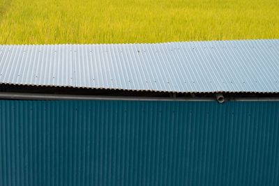 High angle view of corrugated iron by grassy field