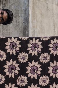 Portrait of woman standing against wall