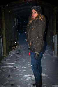 Portrait of woman standing in snow