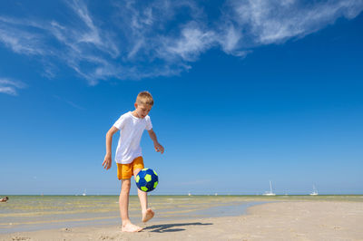 Full length of man on beach against sky