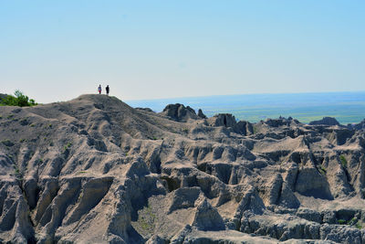 Panoramic shot of rocks on sea against clear sky