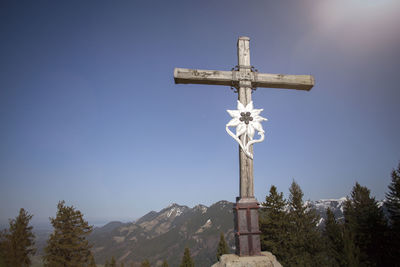 Summit cross of mountain heuberg, bavaria, springtime