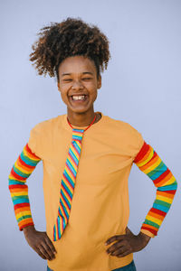 Portrait of young woman standing against white background