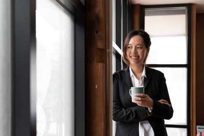 Portrait of young woman using mobile phone