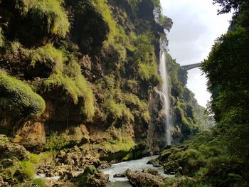 Scenic view of waterfall against sky
