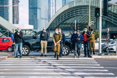 People crossing road in city