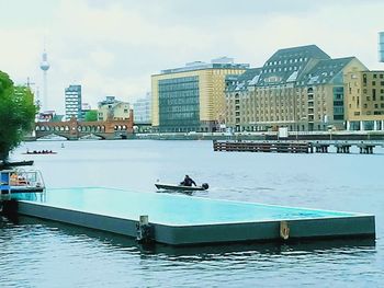 Nautical vessel on sea against sky in city