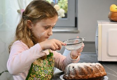 Girl powdering cake