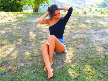 Portrait of a smiling young woman on field