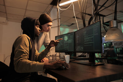 Side view of young man working at office