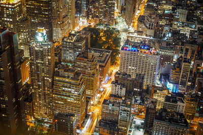 High angle view of city lit up at night