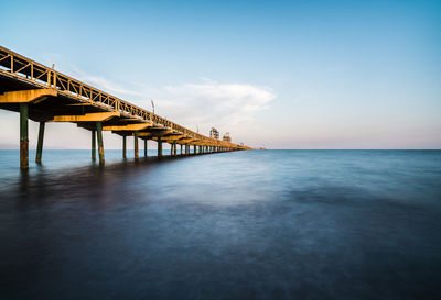 Pier over sea against sky