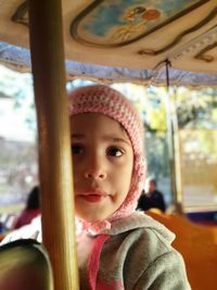 Close-up of girl on carousel at amusement park