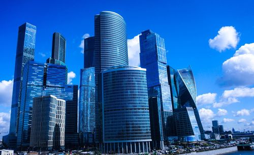 Skyscrapers in city against blue sky