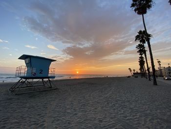 Scenic view of beach against sky during sunset