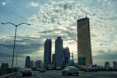 View of skyscrapers against cloudy sky