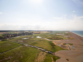 High angle view of green landscape against sky