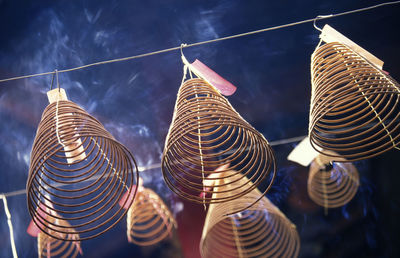 Low angle view of spiral incense sticks in temple