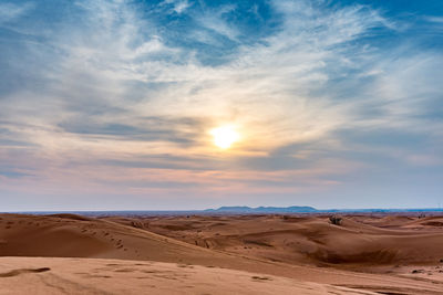 Scenic view of desert against sky during sunset