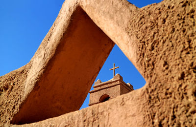 Cross of the bell tower of church of san pedro de atacama in el loa province of northern chile