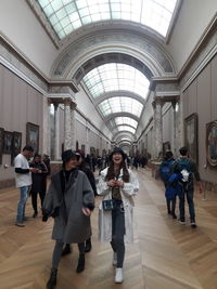 People standing in corridor of building