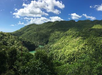 Scenic view of green mountains against sky