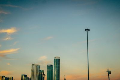 Street lights against sky during sunset