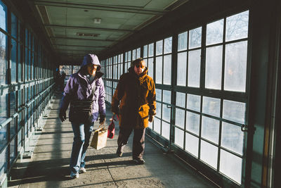 Full length of woman standing by railing