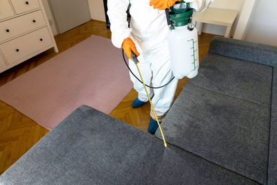 Low section of man standing on floor at home