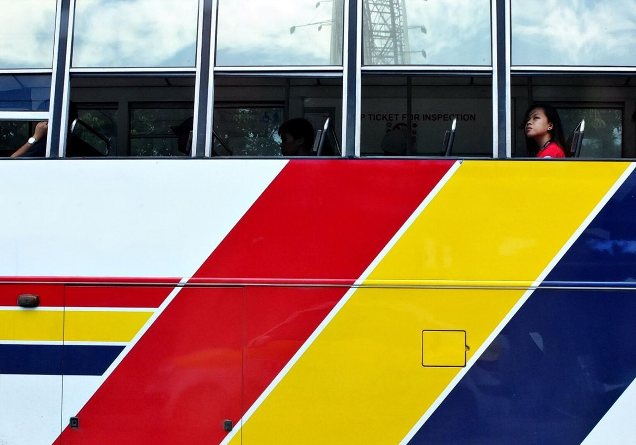 yellow, transportation, built structure, architecture, day, mode of transport, window, public transportation, travel, building exterior, outdoors, red, protection, multi colored, lifestyles, sky, safety, men, airport