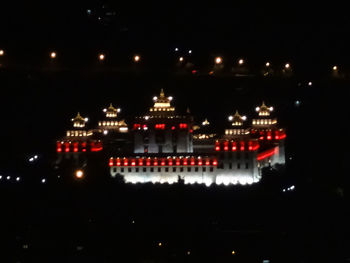 Illuminated city against sky at night