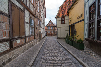 Empty alley amidst buildings in city