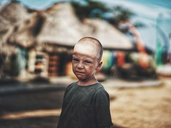 Portrait of smiling boy standing outdoors