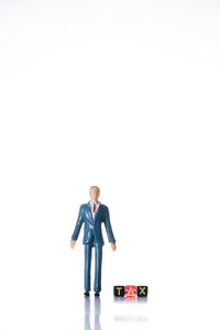 Man with toy standing against white background