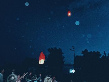 Low angle view of illuminated tower against clear sky