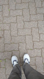 Low section of man standing on footpath