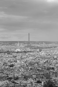 View of cityscape against cloudy sky
