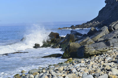 Pacific ocean wave splah against rocky shore of baja california sur in mexico