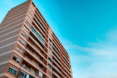 Low angle view of modern building against clear blue sky