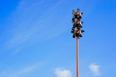Low angle view of street light against blue sky