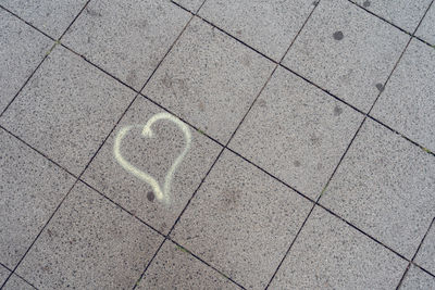 High angle view of heart shape on tiled floor