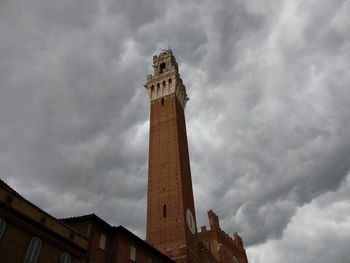 Low angle view of tower against cloudy sky