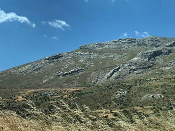 Low angle view of mountain against blue sky