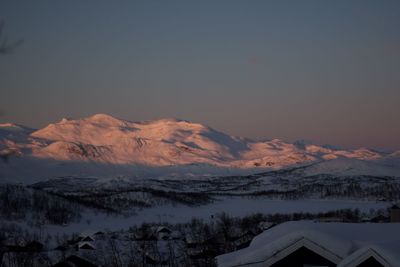 Scenic view of snowcapped mountains against sky during sunset