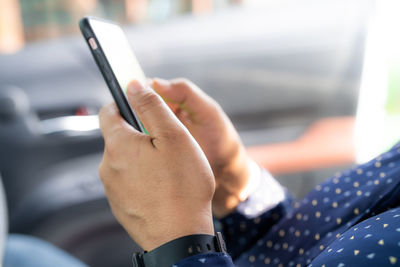 Midsection of man using mobile phone
