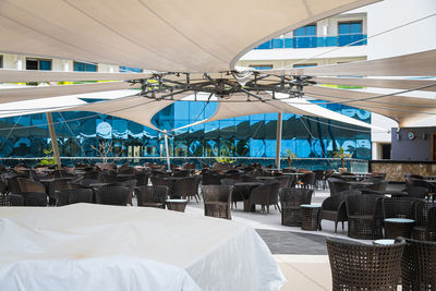 Empty chairs and tables in restaurant