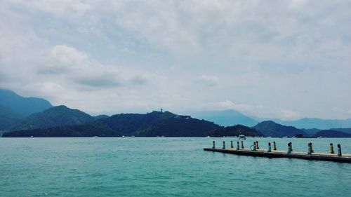 Scenic view of mountains against cloudy sky